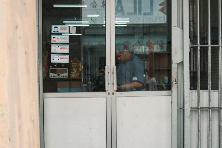 A man sitting at a table in front of a restaurant